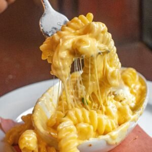 Close-up of macaroni and cheese with melting cheese, irresistible and mouthwatering.