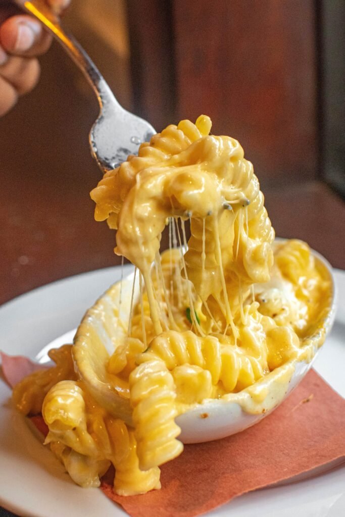 Close-up of macaroni and cheese with melting cheese, irresistible and mouthwatering.